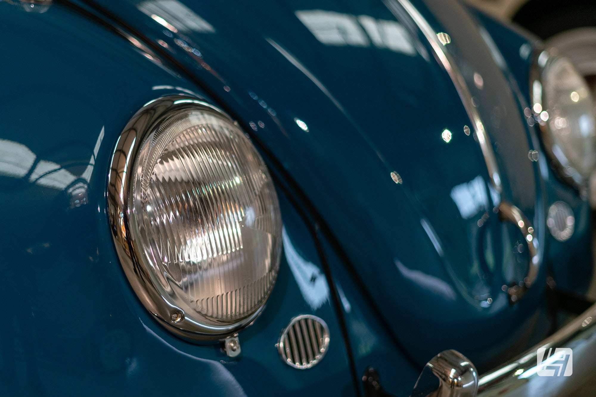 Early headlamps and horn grilles on Sea Blue 1965 VW Beetle