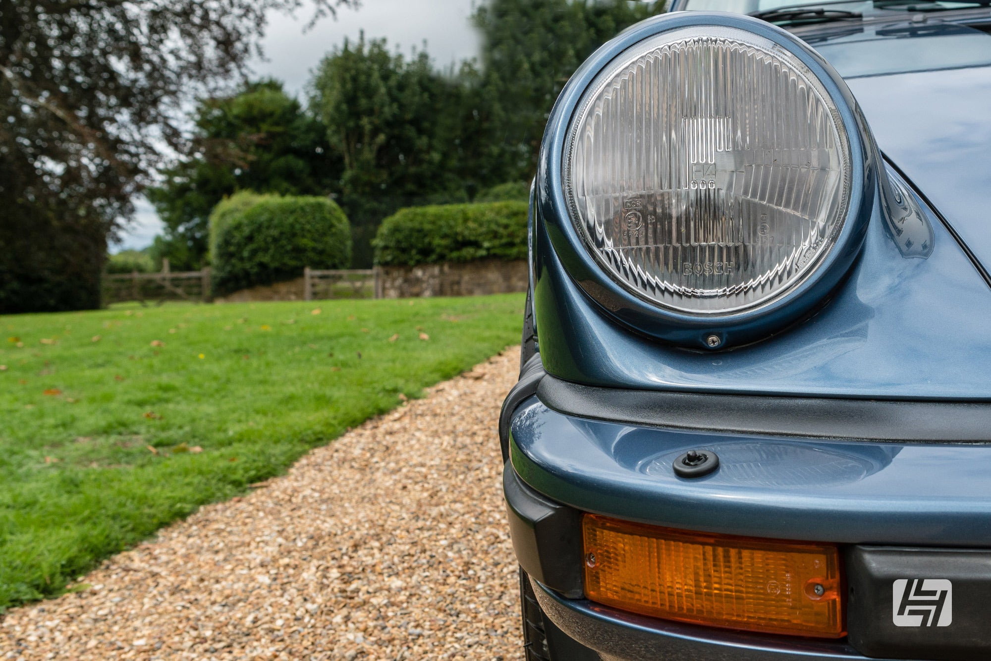 Close up of blue Porsche 911 Gbody with amber front indicators fitted in the bumper