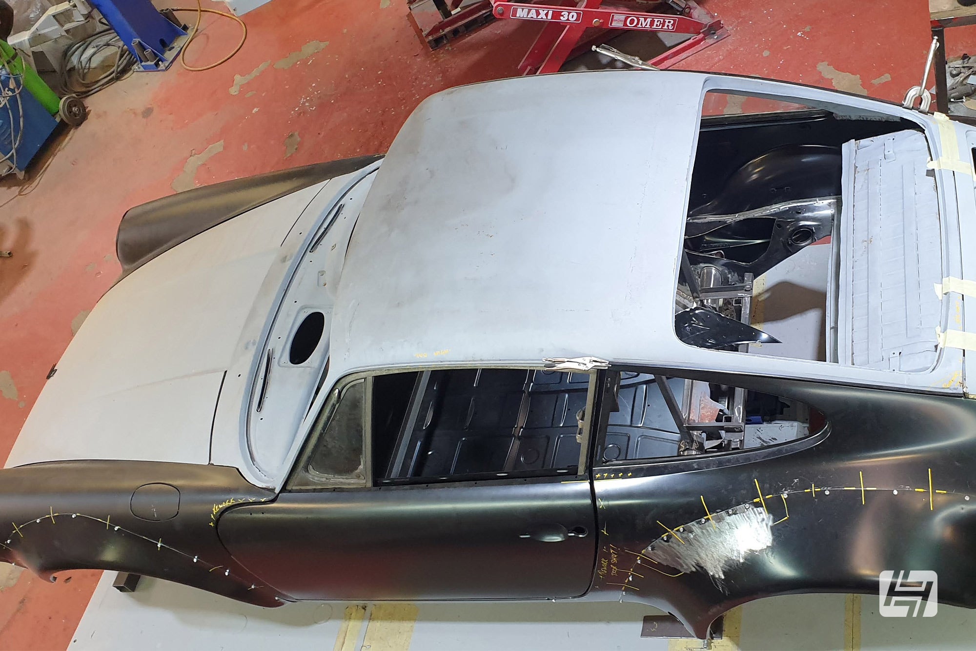 Bare shell of Porsche 911 with sunroof delete panel installed 