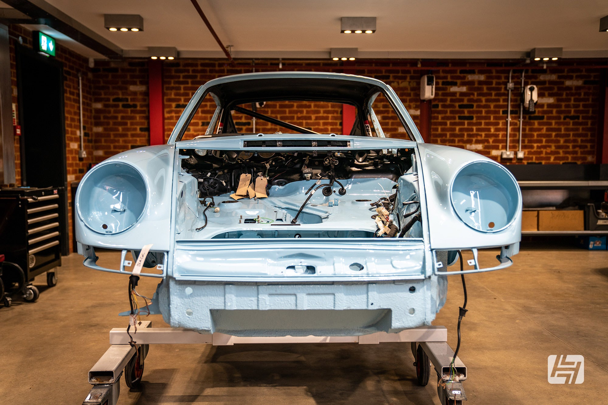 Front end photo of painted Porsche 911 project being reassembled at AutoFarm
