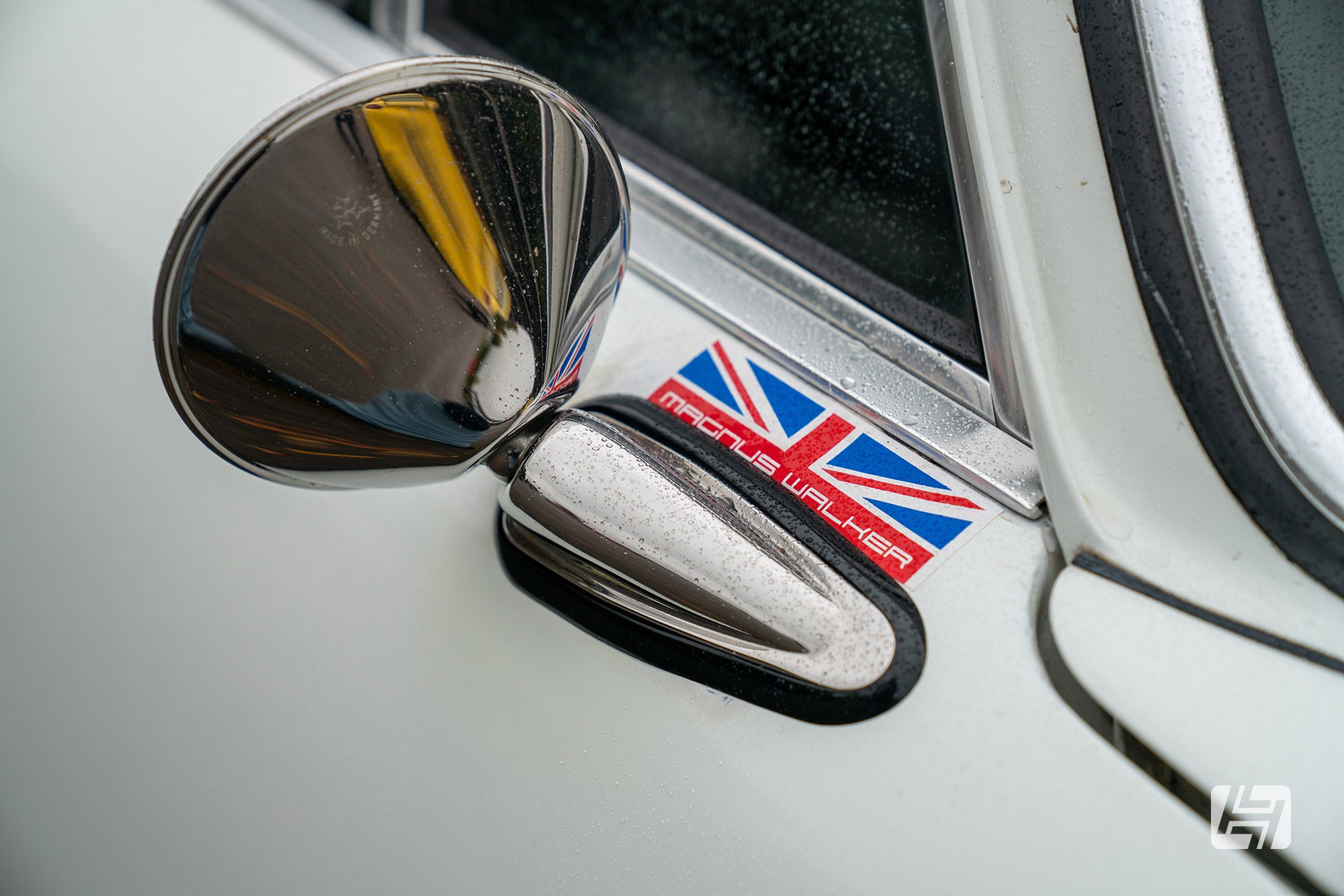 Durant style Porsche 911 mirror fitted to white car with Magnus Walker sticker