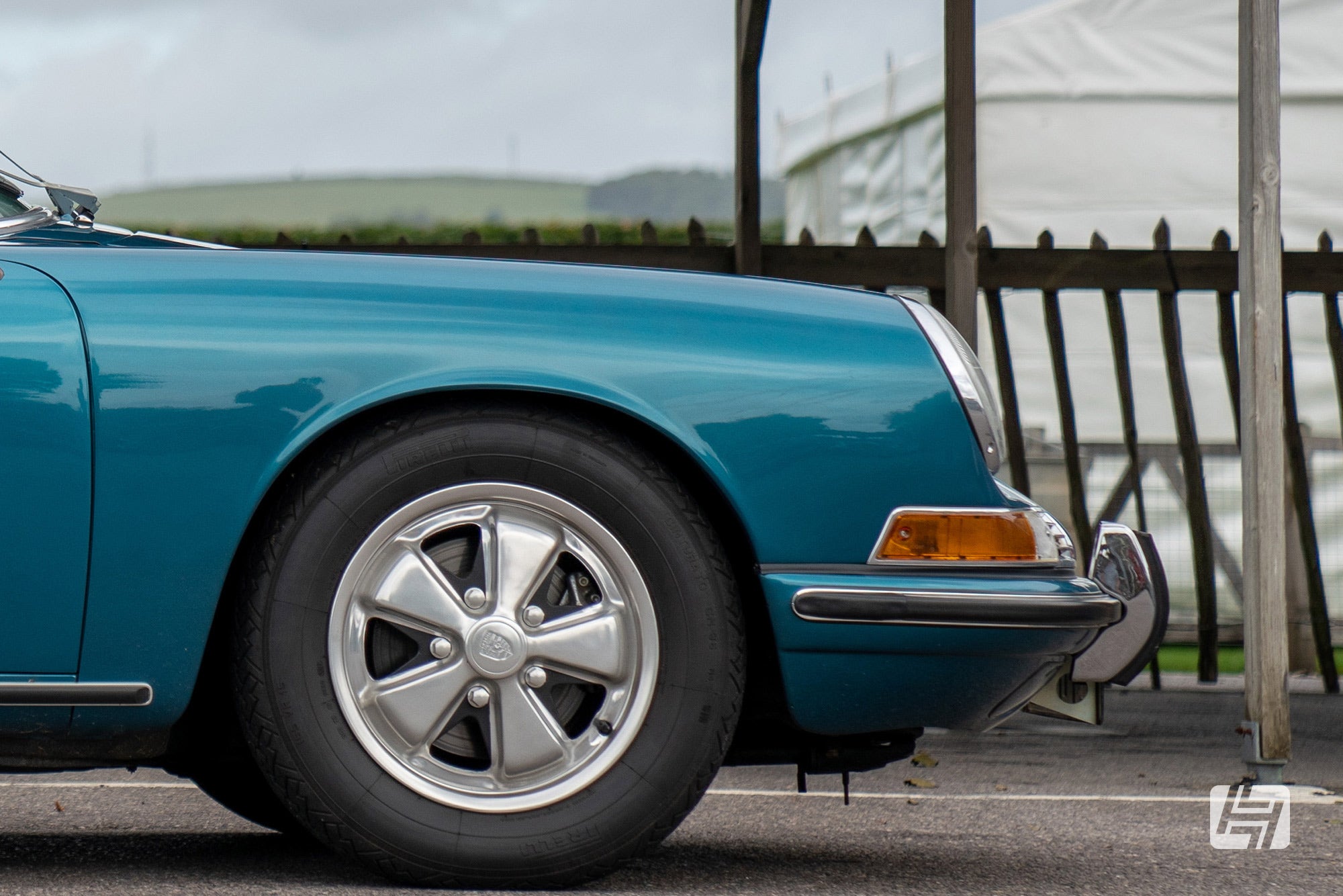 Front wing and front wheel of green Porsche 911S with polished Fuchs wheels fitted