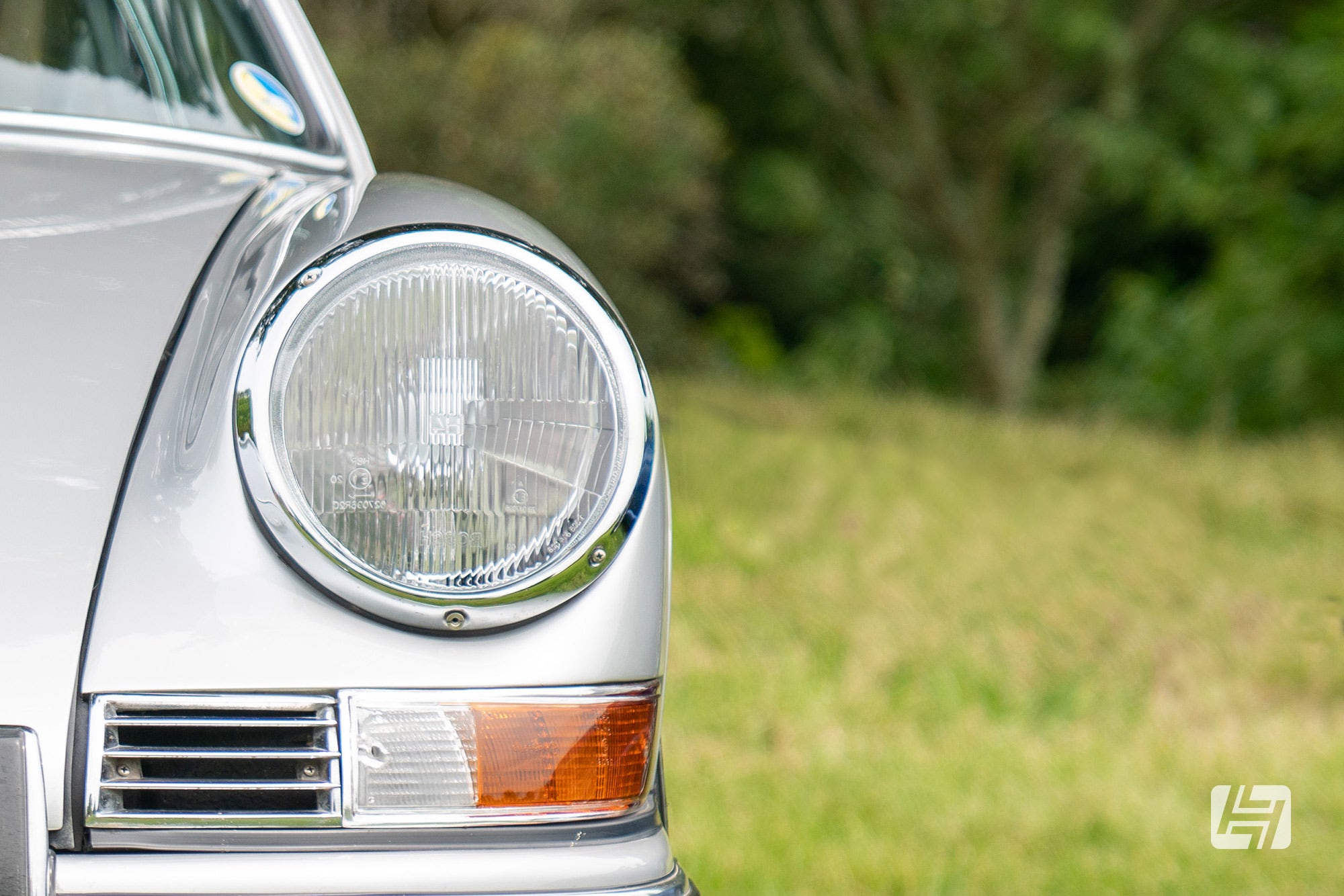 Close up of lcassic Porsche 911 headlamp and front indicator